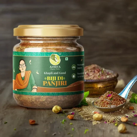A jar of Dry Fruit "Biji Di Panjiri" placed on a rustic wooden surface, with a spoonful of panjiri beside it, showcasing its rich ingredients.