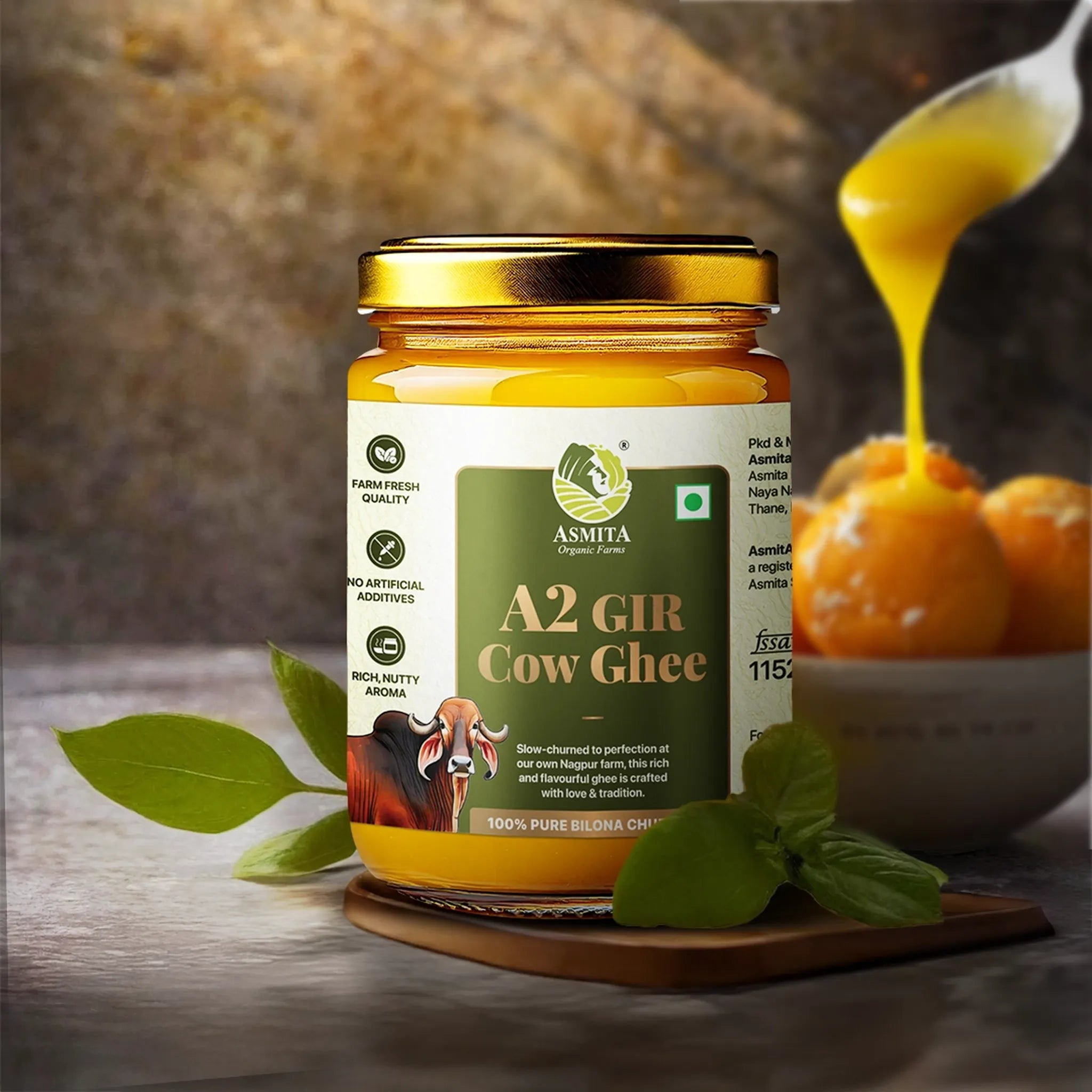 Jar of A2 Gir Cow Ghee with a spoonful of ghee and fruits on a wooden surface.