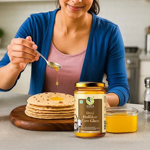 Woman pouring cow ghee from a jar onto flatbreads with a spoon.