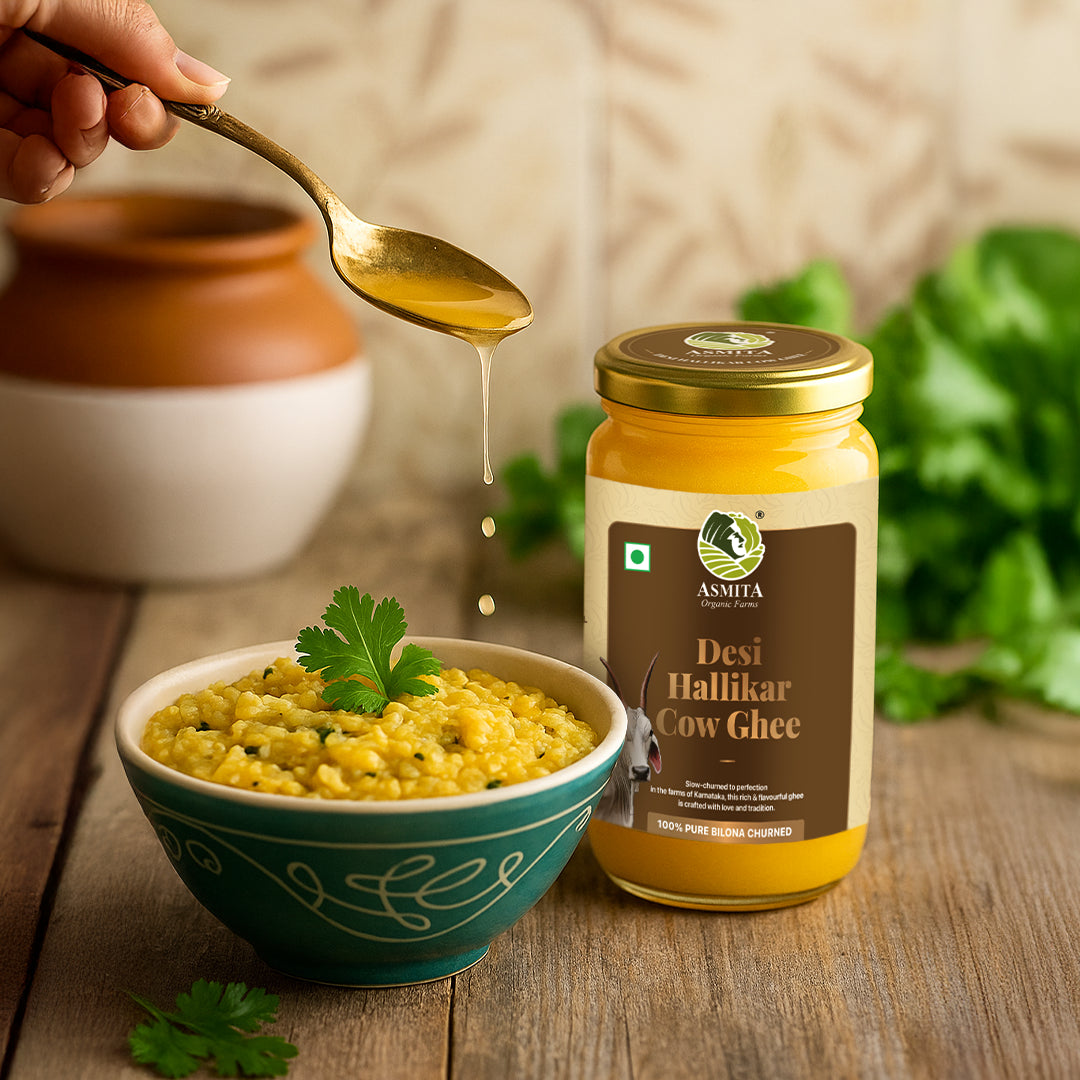 Desi Hallikar Cow Ghee being poured from a spoon into a bowl with a jar of the product in the background.