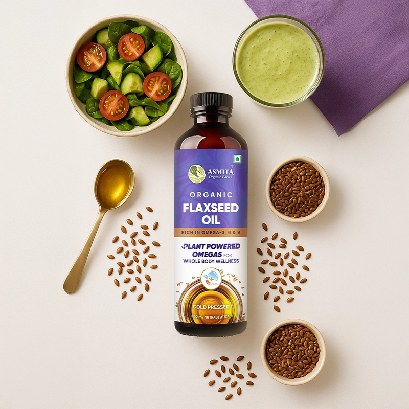 Asmita Organic Flaxseed Oil bottle with flaxseeds, a salad, and a smoothie on a white background