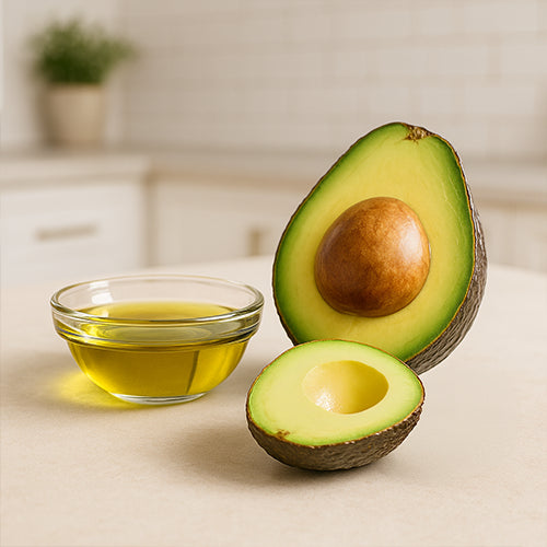 Avocado and a bowl of avocado oil