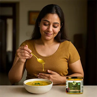 Woman holding a spoon over a bowl of soup with a jar of A2 milk next to it.